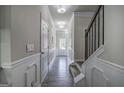 Long hallway featuring hardwood floors, wainscoting, multiple doors, and recessed lighting at 158 Bryon Ln, Acworth, GA 30102