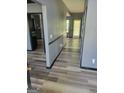 Spacious hallway featuring wood-look floors, neutral paint, and access to multiple rooms at 692 Sedgwick Dr, Jonesboro, GA 30238