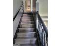 Carpeted staircase with a dark railing leading to the upper level of the home at 692 Sedgwick Dr, Jonesboro, GA 30238