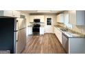 Bright kitchen with white cabinets, granite counters, and stainless steel appliances at 3670 Broadview Ct, Decatur, GA 30032