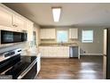 Modern kitchen featuring white cabinets, stainless steel appliances, and granite countertops at 3670 Broadview Ct, Decatur, GA 30032
