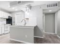 Bright kitchen with white cabinets, bar top, stainless appliances, and a gray backsplash at 113 Tuxworth Cir, Decatur, GA 30033