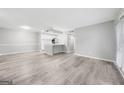 Bright living room with new gray floors and kitchen pass through at 113 Tuxworth Cir, Decatur, GA 30033