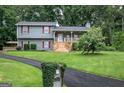 Attractive split-level home with well-kept lawn, mature trees, and charming front porch at 123 Mill, Dallas, GA 30157