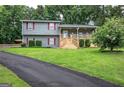 Well-maintained home with a spacious front yard and a welcoming porch with wooden stairs at 123 Mill, Dallas, GA 30157