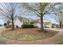 View of a single-Gathering home with a two-car garage and lawn at 1765 Neighborhood Walk, Mcdonough, GA 30252