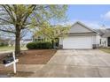 View of a single-Gathering home with a two-car garage and mailbox at 1765 Neighborhood Walk, Mcdonough, GA 30252