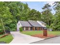 Attractive home featuring a well-kept lawn, inviting porch with wood columns, and a modern mailbox at 347 Chip Rd, Stone Mountain, GA 30087