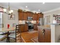 Well-appointed kitchen featuring custom cabinets, stainless steel appliances, and a cozy eat-in area at 409 Brandy Ln, Mcdonough, GA 30253