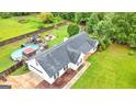 Back aerial of a home with a fenced yard, pool, and deck at 1195 New Hope Rd, Locust Grove, GA 30248
