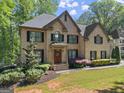 Lovely brick two-story home with mature landscaping, creating an inviting curb appeal at 4680 Brighton Lake Dr, Cumming, GA 30040