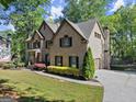 Charming two-story brick home with side-entry garage, mature trees and landscaped yard at 4680 Brighton Lake Dr, Cumming, GA 30040