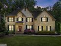 Inviting two-story brick home with manicured lawn and inviting entrance at 4680 Brighton Lake Dr, Cumming, GA 30040