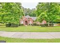 Charming brick home with lush green lawn and mature trees at 835 Virginia Parks, Fayetteville, GA 30215