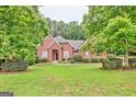 Inviting brick home with lush green lawn and mature trees at 835 Virginia Parks, Fayetteville, GA 30215