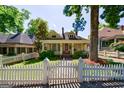 Quaint yellow home with a white picket fence and a well-manicured front yard at 381 Cherokee Se Ave, Atlanta, GA 30312