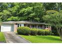 A charming brick home with a one-car garage and a well-maintained front yard at 766 Virginia Cir, Forest Park, GA 30297
