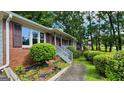 Brick home exterior showing shuttered windows, updated railings, and manicured landscaping at 766 Virginia Cir, Forest Park, GA 30297