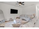 Bright living room featuring a comfortable sofa and large window at 23 Skyland W Dr, Locust Grove, GA 30248