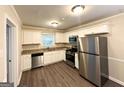 Modern kitchen featuring stainless steel appliances, granite countertops, and white cabinets with dark floors at 3115 Pinehill Dr, Decatur, GA 30032