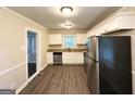 Well-lit kitchen featuring stainless steel appliances, white cabinets, granite countertops, and dark floors at 3115 Pinehill Dr, Decatur, GA 30032