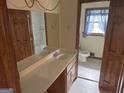 Bathroom featuring a double vanity with lots of space, wood cabinetry, and tile floors at 5125 Flakes Mill Rd, Ellenwood, GA 30294
