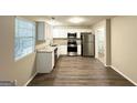 Modern kitchen with stainless steel appliances and ample counter space for cooking at 1362 Mill Lake Cir, Stone Mountain, GA 30088