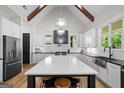 Spacious kitchen with a large island, white cabinetry, stainless steel appliances, and modern pendant lighting at 2490 S Carroll St, Villa Rica, GA 30180