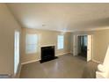 Bright living room with tile flooring, neutral walls, and a fireplace for cozy evenings at 2146 Wingfoot Pl, Decatur, GA 30035