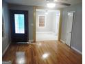 Inviting living room featuring hardwood floors, an open layout, and a front door with decorative glass at 4814 Glenwood Rd, Decatur, GA 30035