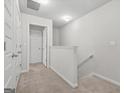 Upstairs hallway features neutral carpet, white trim, and doors leading to various rooms at 4076 Sonoma Wood, Decatur, GA 30034