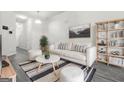 Bright living room with a white sofa, striped rug, decorative pillows, and modern decor at 4076 Sonoma Wood, Decatur, GA 30034