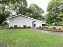 Exterior view of a grey painted brick home with tidy landscaping at 1918 Leigh Sw Dr, Conyers, GA 30094