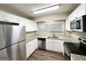 Kitchen with stainless steel appliances, granite countertops, and white cabinets at 1918 Leigh Sw Dr, Conyers, GA 30094