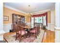 Formal dining room featuring hardwood floors, decorative rug, and custom window treatments at 235 Ashley Forest Dr, Fayetteville, GA 30214