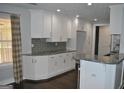 Modern kitchen featuring white cabinets, granite counters, and stainless steel appliances at 803 Pointe Trl, Locust Grove, GA 30248