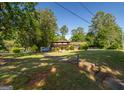 Classic exterior showcasing a well-kept lawn and mature trees surrounding this charming two-story home at 6214 Crestview Se Dr, Covington, GA 30014