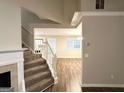 An open living room with a staircase, seamlessly connecting to the dining area through a bright doorway at 9124 Comstock Ct, Covington, GA 30014