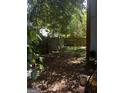 An overgrown and wooded backyard with a wooden fence, offering privacy at 8636 Woodside Ln, Jonesboro, GA 30238