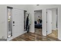 Foyer with wood-look flooring, white doors, and coat rack, providing a functional space at 3430 Grand Manor Trl, Snellville, GA 30039