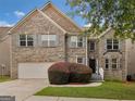 Beautiful brick home with a two-car garage and well-maintained landscaping at 3430 Grand Manor Trl, Snellville, GA 30039