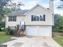 Charming two-story home with a two-car garage and a well-maintained front yard at 4411 Ward Bluff Ct, Ellenwood, GA 30294