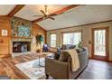 Cozy living room featuring a fireplace and vaulted ceilings, perfect for relaxing at 3452 Monica Sw Ln, Conyers, GA 30094