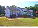 Attractive home showcasing a two-car garage, nice lawn, and an inviting curb appeal at 221 Ashley Trace Dr, Locust Grove, GA 30248