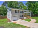 View of the charming white brick home showing the attached garage and pathway to the front door at 1026 Ponderosa Park Dr, Forest Park, GA 30297