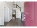 Open foyer with hardwood flooring, staircase, and view into the dining room at 3842 Monticello St, Douglasville, GA 30135