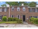 Traditional brick townhome with symmetrical facade, multi-pane windows and manicured greenery at 244 Timber Creek Ln, Marietta, GA 30060