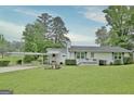 Charming single-story home featuring a carport, well-maintained lawn, and inviting front porch at 270 E James Cir, Hampton, GA 30228