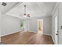 Spacious main bedroom featuring a tray ceiling, ceiling fan, and wood floors, offering a bright and open feel at 40 Wenham Ln, Sharpsburg, GA 30277