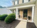Inviting front porch with brick facade, decorative columns, and manicured landscaping at 789 Winbrook Dr # 1, Mcdonough, GA 30253